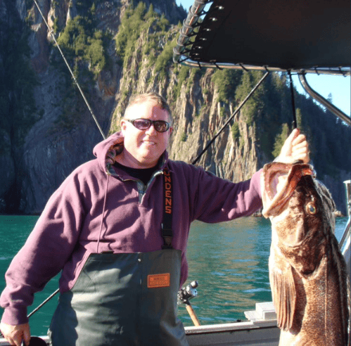 Barry Burnett holding Fish Barry fishing - PC Fishing trip.