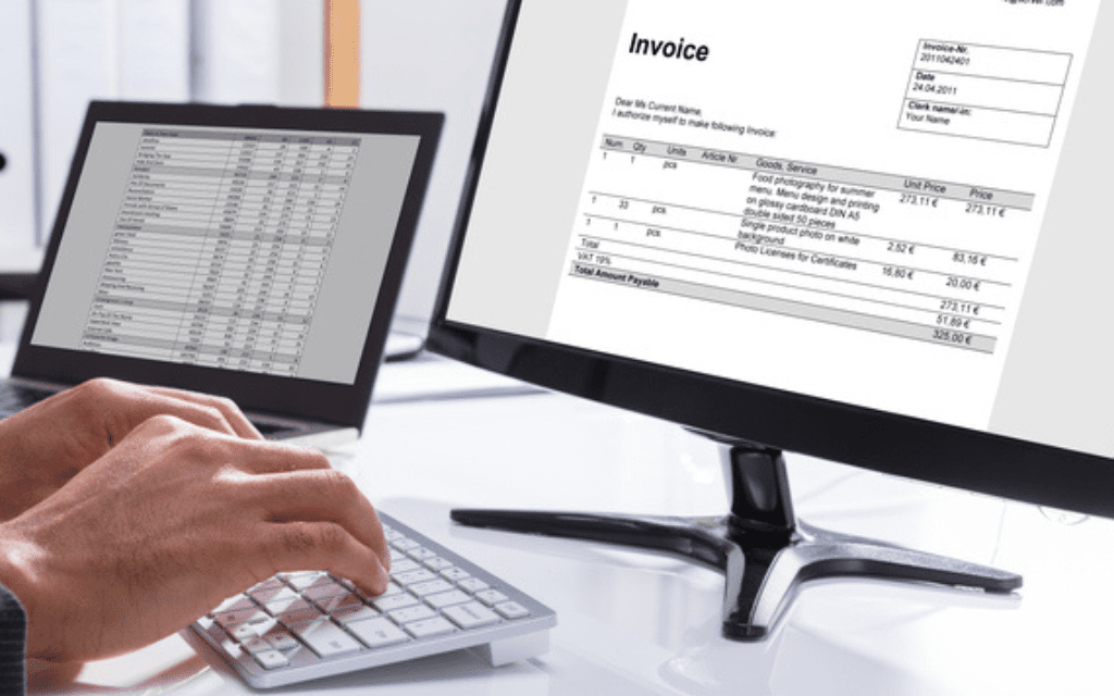Using a computer to look at an invoice
