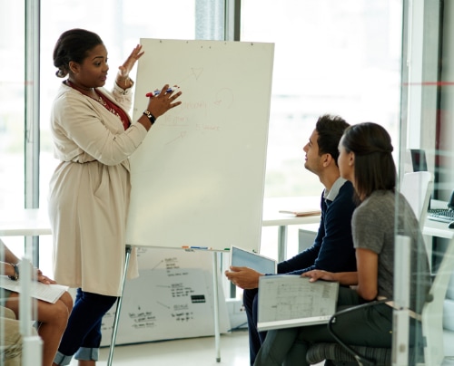 Woman presenting to man and woman.