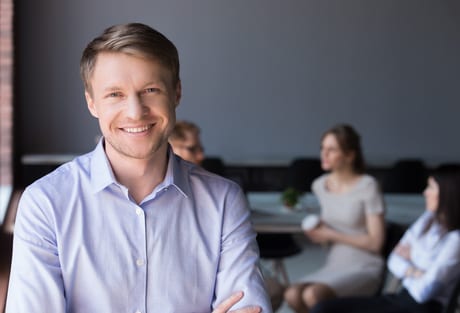 Male office employee smiling