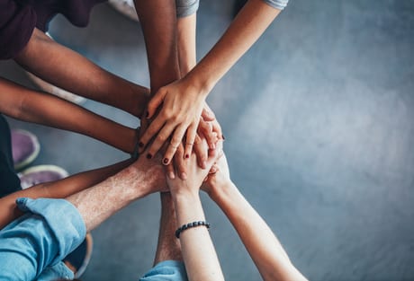 A group of hands on top of each other